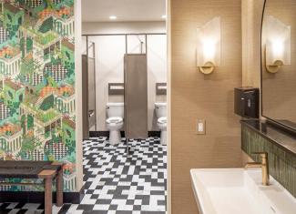 Event venue restroom interior with a modern design featuring Flushmate pressure-assisted toilets.